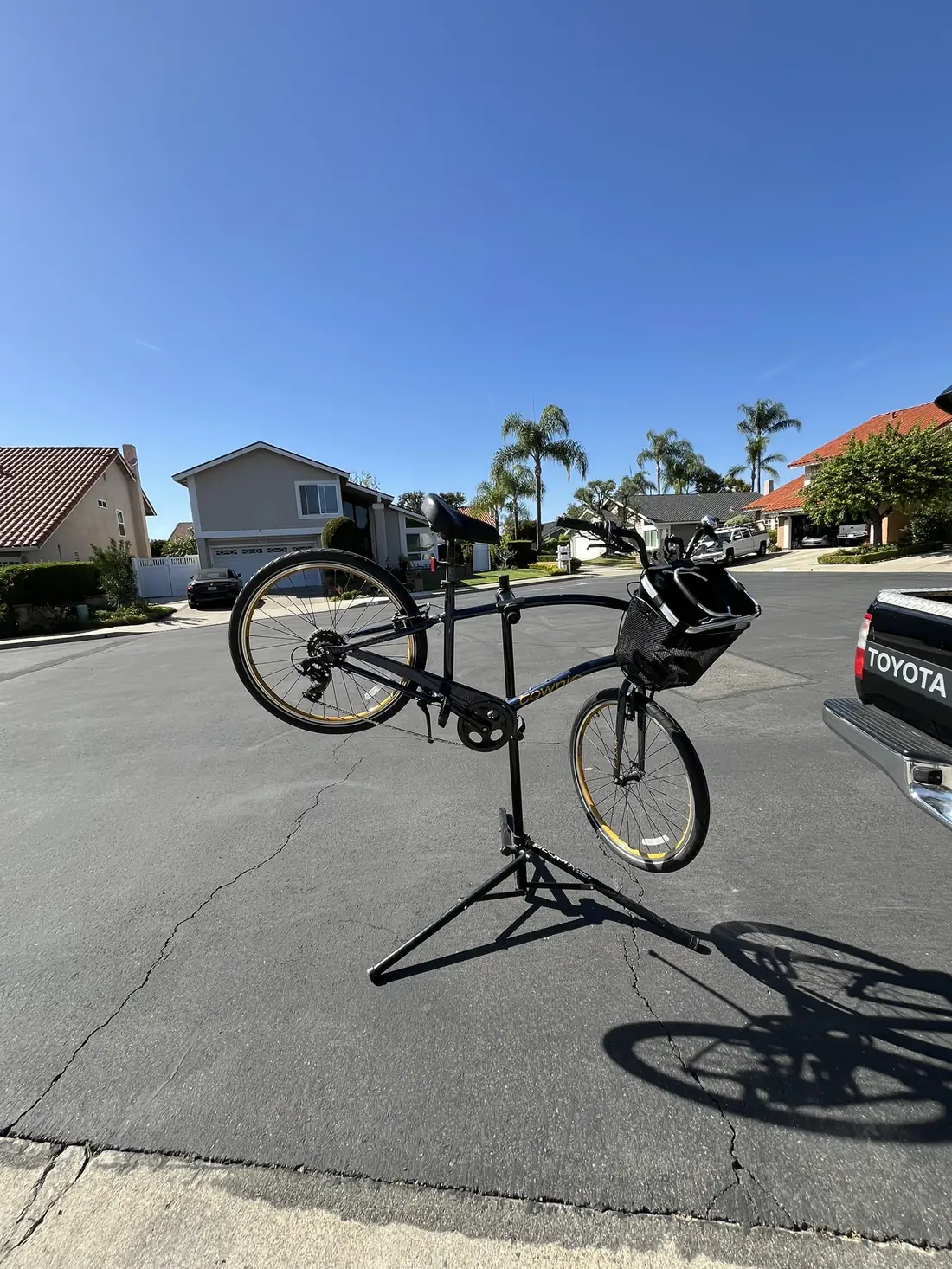 Mountain bike on repair stand in driveway