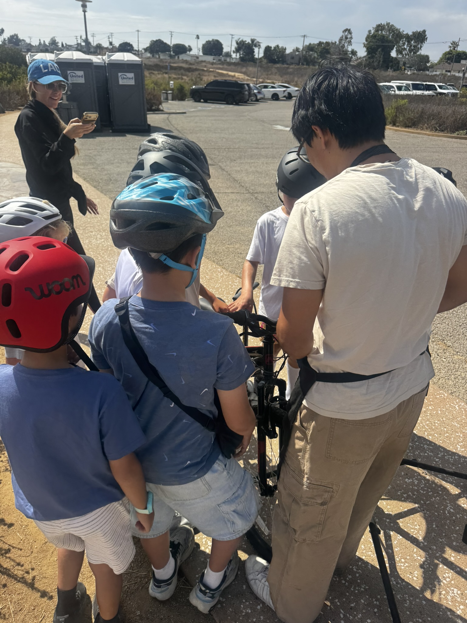 Cub Scouts gathering with their bikes and helmets before the safety station begins