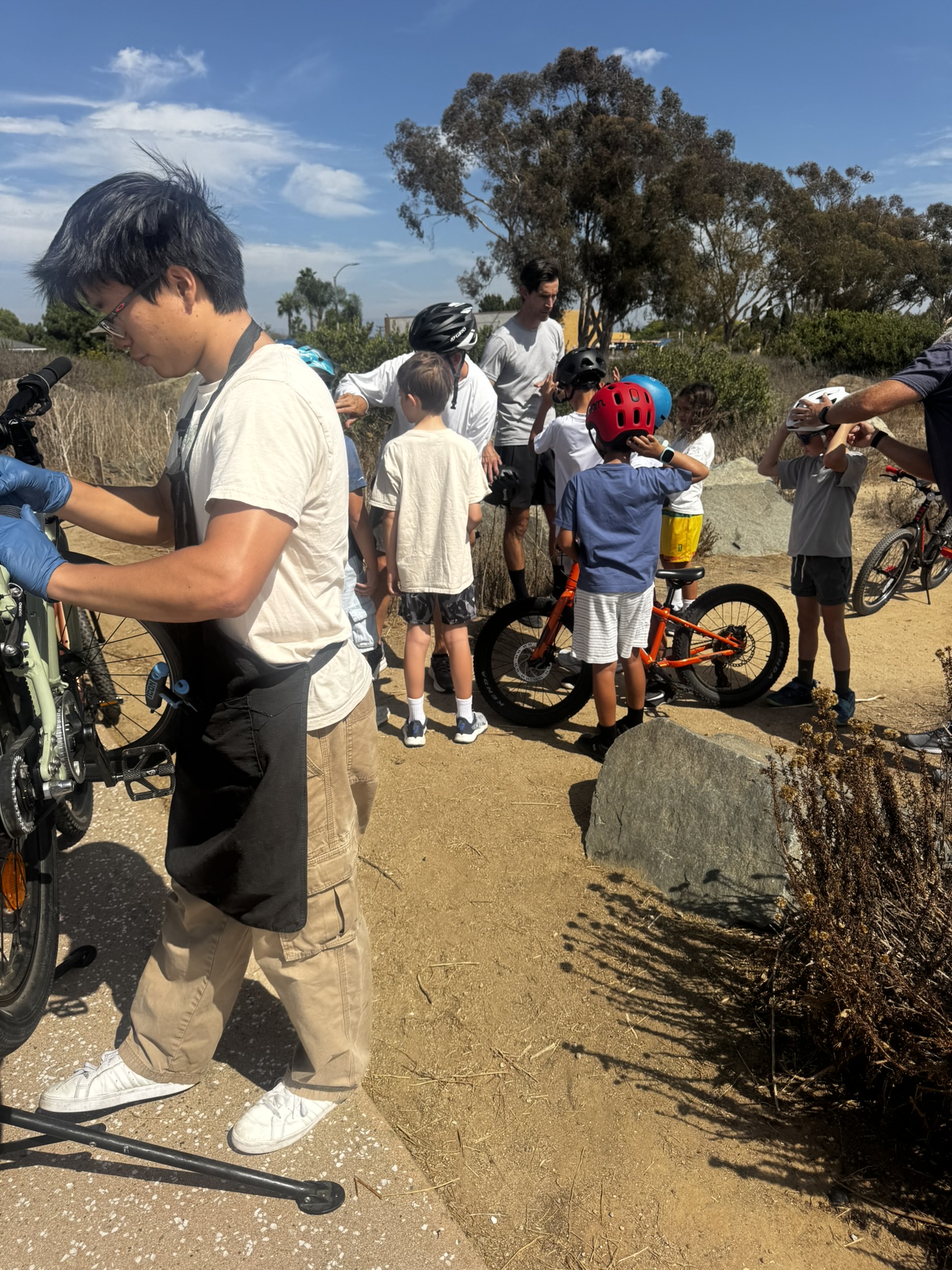 The den regrouping on the trail with bikes and helmets