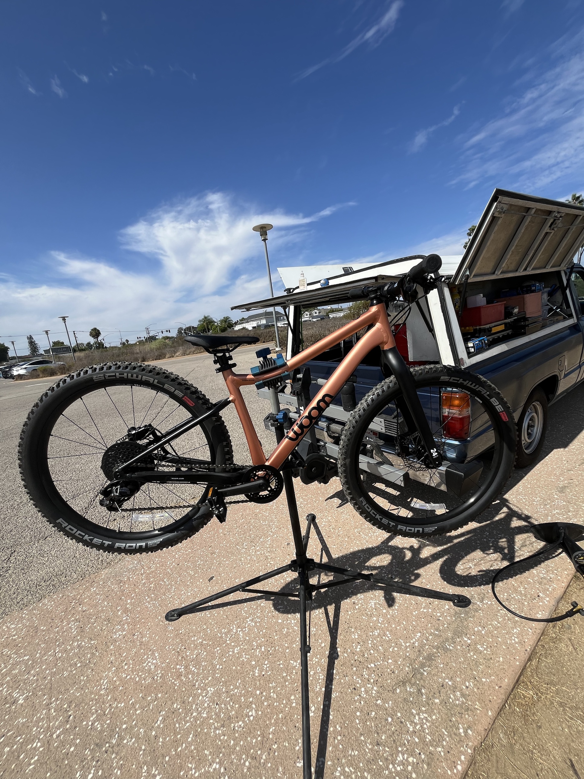 Inspecting a Woom mountain bike on the repair stand before the ride